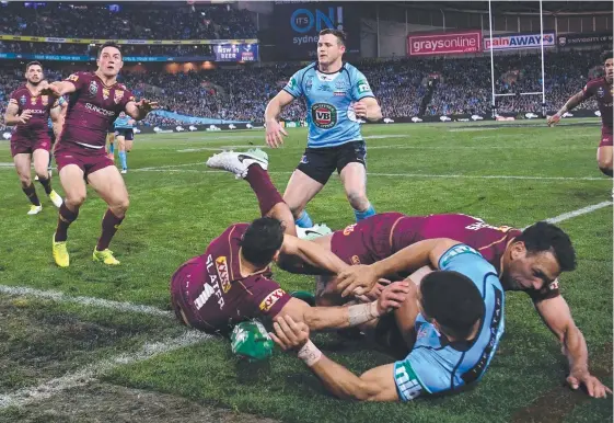  ?? Picture: AAP IMAGE ?? Queensland’s Will Chambers, with the help of Billy Slater, bundles Jarryd Hayne into touch during Game Two.