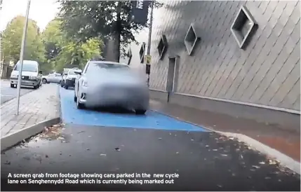  ??  ?? A screen grab from footage showing cars parked in the new cycle lane on Senghennyd­d Road which is currently being marked out