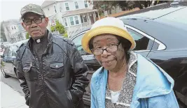  ?? STAFF PHOTOS BY MATT STONE ?? GRIEVING: Bishop Alexander Allen Sr. and his wife, Mary, parents of murder victim Alexander J. Allen, talk about their son yesterday. Allen’s widow, Dola Thelwell-Allen, holds a photo of her and her husband.