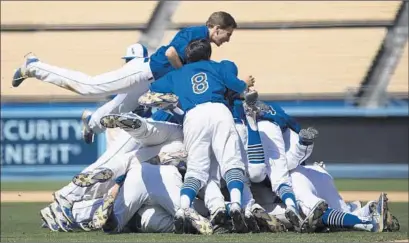  ?? Photog raphs by Allen J. Schaben Los Angeles Times ?? EL CAMINO REAL players pile on each other after winning City Section Division I title over Cleveland at Dodger Stadium.