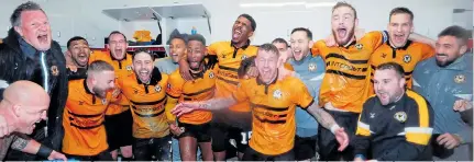  ??  ?? Cup shock: Newport County players – minus new dad Joe – celebrate in the dressing room after stunning win