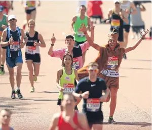  ??  ?? Runners sweltered during the warmest London Marathon on record