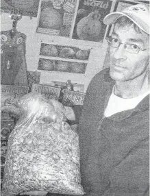  ?? FILE ?? In 2007, Danny Dill, of College Road in Windsor, shows off a bag of the world-famous Atlantic Giant pumpkin seeds that his late father, Howard, first developed and trademarke­d. The family farm had just inked a deal with Lowe’s in the United States to carry the giant pumpkin seeds.