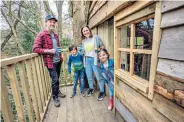  ??  ?? g James Bloor, pictured with his wife Kerrina and their children, has built a treehouse in the garden