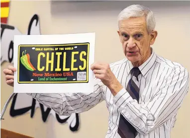  ?? ADOLPHE PIERRE-LOUIS/JOURNAL ?? Bill Johnston, with The New Mexico Transporta­tion History Project, talks about the design of the red and green chile New Mexico license plate, which was voted the best license plate in the U.S.