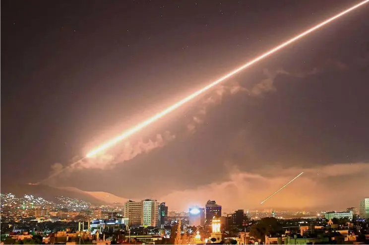  ??  ?? Defence strategy: Syrian forces launching surface-to-air missiles in Damascus during the US-led attack on the country. — AP