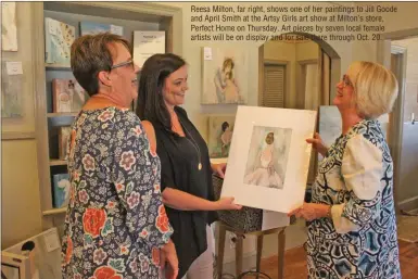  ??  ?? Reesa Milton, far right, shows one of her paintings to Jill Goode and April Smith at the Artsy Girls art show at Milton’s store, Perfect Home on Thursday. Art pieces by seven local female artists will be on display and for sale there through Oct. 20.