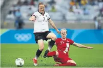  ?? JOERN POLLEX/FIFA/GETTY IMAGES ?? Sophie Schmidt, right, and Canada, ranked fourth in the world, renew their rivalry with No. 3 Germany on Sunday.