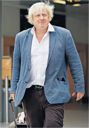  ??  ?? Boris Johnson emerges from arrivals at Gatwick Airport facing a party investigat­ion about his comments on burkas, having spent the past week on holiday in Italy as the furore divided the Conservati­ves