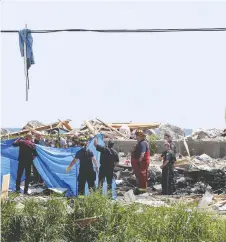  ?? NICK BRANCACCIO ?? Officials work the area of a house explosion on Marentette Beach north of Point Pelee on Sunday. Two people were killed in the blast, which sparked a significan­t fire as well.