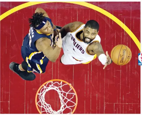  ??  ?? Cleveland Cavaliers’ Kyrie Irving, right, drives to the basket against Indiana Pacers’ Myles Turner in the first half in Game 2 of a first- round NBA basketball playoff series Monday, in Cleveland. (AP)