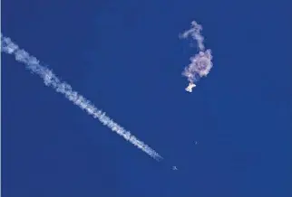  ?? Chad Fish/AP ?? A missile fired on Feb. 4 by an F-22 off the South Carolina coast ended the dayslong flight of a suspected Chinese balloon. It was the first of more reports of other unidentifi­ed objects.