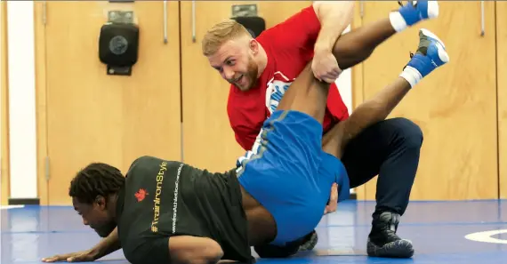  ?? JACK BOLAND ?? Canadian Clayton Pye, top, shown here training, could have another shot at the Olympics if a last-chance wrestling qualifier goes ahead as planned in Bulgaria this June.