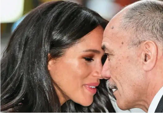  ??  ?? Paying respects: Meghan shares a Maori greeting with New Zealand High Commission­er Sir Jerry Mateparae yesterday