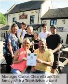  ??  ?? Manager Carlos Chiarella and his family with a TripAdviso­r award