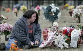  ?? GERRY BROOME — THE ASSOCIATED PRESS ?? Amy Pittman visits the grave of her son, Christian, in Durham, N.C., on Friday. Pittman was charged in 2014 with manslaught­er after 9-year-old Christian was accidental­ly shot and killed by his older brother.