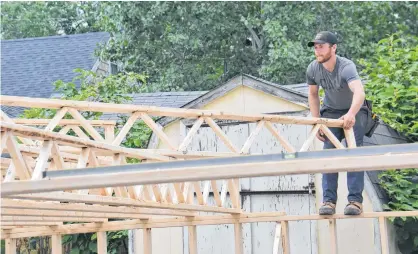  ?? STU NEATBY/THE GUARDIAN ?? Chron MacVittie of MacVittie Constructi­on works on an addition to a business on Kensington Road. MLAs recently heard that there is currently a shortage of almost 300 tradeswork­ers in P.E.I.