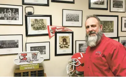  ?? KEITH GROLLER/THE MORNING CALL ?? Retiring Easton athletic director Jim Pokrivsak is surrounded by original team photos and other Red Rovers memorabili­a as he spends one of his final days in the high school athletic office.