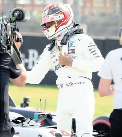  ?? JENS MEYER ?? Mercedes driver Lewis Hamilton celebrates after he clocked the fastest time after the qualifying session during the qualifying Formula One session at the Hockenheim­ring racetrack in Hockenheim, Germany, yesterday.