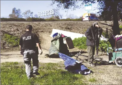  ?? BEA AHBECK/NEWS-SENTINEL ?? Lodi police officer Richard Dunfee checks out a homeless camp under Highway 99 by Turner Road in Lodi in 2019. The San Joaquin County Board of Supervisor­s voted on Tuesday to approved millions of dollars in funding requests for homeless access centers in Lodi, Manteca and Tracy.