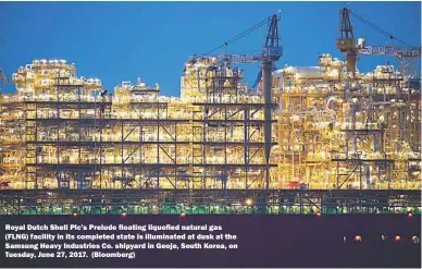  ??  ?? Royal Dutch Shell Plc’s Prelude floating liquefied natural gas (FLNG) facility in its completed state is illuminate­d at dusk at the Samsung Heavy Industries Co. shipyard in Geoje, South Korea, on Tuesday, June 27, 2017. (Bloomberg)