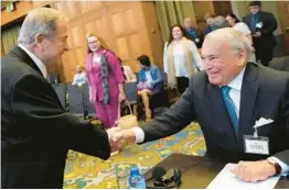  ?? PETER DEJONG/AP ?? Nicaragua’s agent Carlos Jose Arguello Gomez, left, greets Colombia’s agent Eduardo Valencia Ospina on Thursday at the World Court in The Netherland­s.