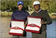  ?? KEVIN KOLCZYNSKI — THE ASSOCIATED PRESS ?? Qass Singh, left, and father Vijay Singh, right, hold the trophies after winning PNC Championsh­ip on Sunday.