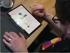  ?? ?? A user of ‘DigiVi’, a dating app developed exclusivel­y for people with mild intellectu­al disabiliti­es or autism, browses the platform on his device at a cafe in Uppsala, Sweden.