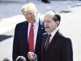  ?? BRENDAN SMIALOWSKI AFP/Getty Images ?? U.S. President Donald Trump listens to Labor Secretary Alexander Acosta as he speaks to the media last Wednesday at the White House.