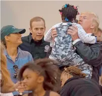  ?? AFP ?? US President Donald Trump and First Lady Melania Trump greet a young Hurricane Harvey victim at NRG Center in Houston. —