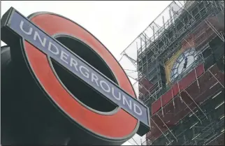  ??  ?? A London Undergroun­d sign is seen at Westminste­r station with Queen Elizabeth Tower in the background holding the bell known as Big Ben in London.