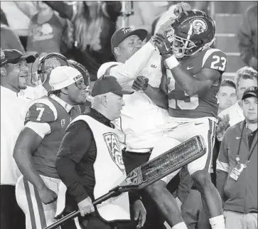  ?? Luis Sinco Los Angeles Times ?? FRESHMAN Kenan Christon (23) celebrates on the sideline during USC’s 41-14 victory over Arizona on Saturday. Christon ran for two touchdowns on a night when Stephen Carr and Markese Stepp suffered injuries.