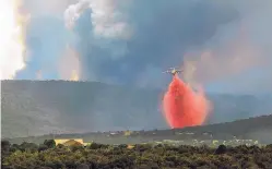  ?? GREG SORBER/JOURNAL ?? A tanker drops retardant on the Dog Head Fire in the Manzano Mountains on Thursday.