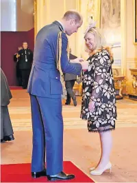  ?? ?? Proud moment Vivien receiving her award from the Duke of Cambridge