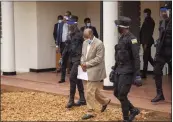  ?? THE NEW YORK TIMES ?? Police escort dissident Paul Rusesabagi­na into a van after his pretrial court appearance in Kigali, Rwanda, in September 2020. He was released from prison Friday.