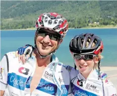  ?? ASHLEE PEARCE ?? Mike Webb and son Alex, 14, relax on a beach near Nelson, B.C., after a day’s ride on the CASA Cycledelic 1000 bike tour.