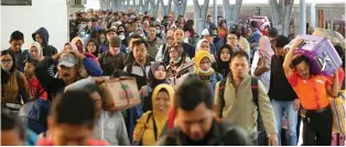  ?? FEDRIK TARIGAN/JAWA POS ?? MASUK KERJA LAGI: Para pemudik turun dari kereta api Gajayana Malang–Jakarta di Stasiun Pasar Senen kemarin (9/6).