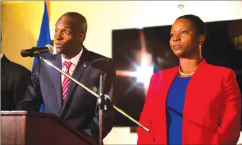  ??  ?? Elected president Jovenel Moise talks next to his wife Martine during his first Press conference