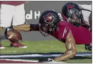  ?? Arkansas Democrat-Gazette/MITCHELL PE MASILUN ?? Receiver Jonathan Adams(left) stretches for a touchdown for Arkansas State on Saturday. The Red Wolves passed for 497 yards and seven touchdowns in the victory.
