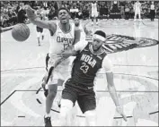  ?? Gerald Herbert Associated Press ?? CLIPPERS GUARD Tyrone Wallace and Pelicans forward Anthony Davis battle near the basket.