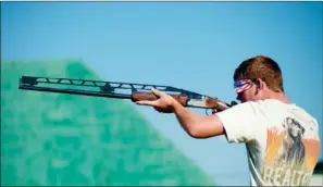  ??  ?? PHOTOS BY RUSTY HUBBARD/THREE RIVERS EDITION
John Riley Wiens looks down the barrel of his shotgun before shooting a clay pigeon.