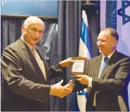  ??  ?? DEAN OF the Honorary Consuls Gad Propper (left) receives an award from Foreign Ministry Chief of Protocol Gil Haskel. (Ortal ben David and Yogev Cohen/Foreign Ministry)