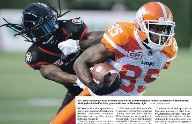  ?? — THE CANADIAN PRESS ?? B.C. Lion Shawn Gore uses his body to shield the ball from Ottawa Redblacks defender Abdul Kanneh during the first half of their game in Ottawa on Thursday night.