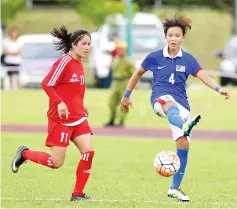 ??  ?? AT THE DOUBLE: Shereilynn Elly Pius (right) scores two in Malaysia’s 4-1 internatio­nal friendly win over Nepal at the UMS Stadium yesterday. - Photo courtesy of Jaiman Taip.