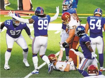  ?? AL BELLO GETTY IMAGES ?? Dexter Lawrence (97) and Leonard Williams of the Giants celebrate after stopping Washington’s Kyle Allen.