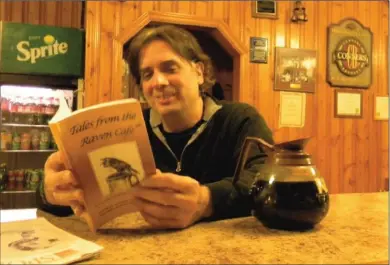  ?? KENNEDY GORDON ?? Dean Pappas flips through a copy of Talesfromt­heravencaf­é, a new book written by eight local writers - Pappas included - at Pappas Billiards on George St. The landmark pool hall and coffee shop is the thinly veiled setting of the book, which features...