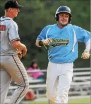  ??  ?? Pottstown’s Angelo Kelly, right, scores in the bottom of the first inning while Collegevil­le starting pitcher Cole Luzins looks on.