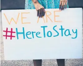  ?? RALPH BARRERA/AUSTIN AMERICAN-STATESMAN 2017 ?? A person holds a sign to protest then-President Trump’s decision to rescind the Deferred Action for Childhood Arrivals program.