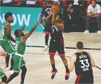  ?? KIM KLEMENT/USA TODAY SPORTS ?? Raptors guard Kyle Lowry takes a shot in front of Celtics counterpar­t Kemba Walker en route to 33 points during Toronto’s Game 6 win on Wednesday in the NBA’s bubble outside Orlando.