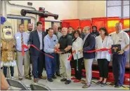  ?? EMILY OVERDORF — FOR MEDIANEWS GROUP ?? School officials, state officials and members of the TriCounty Area join donor Scott Bentley to cut the ribbon on the new Hawkeye Elite wheel alignment system at Pottstown High School.